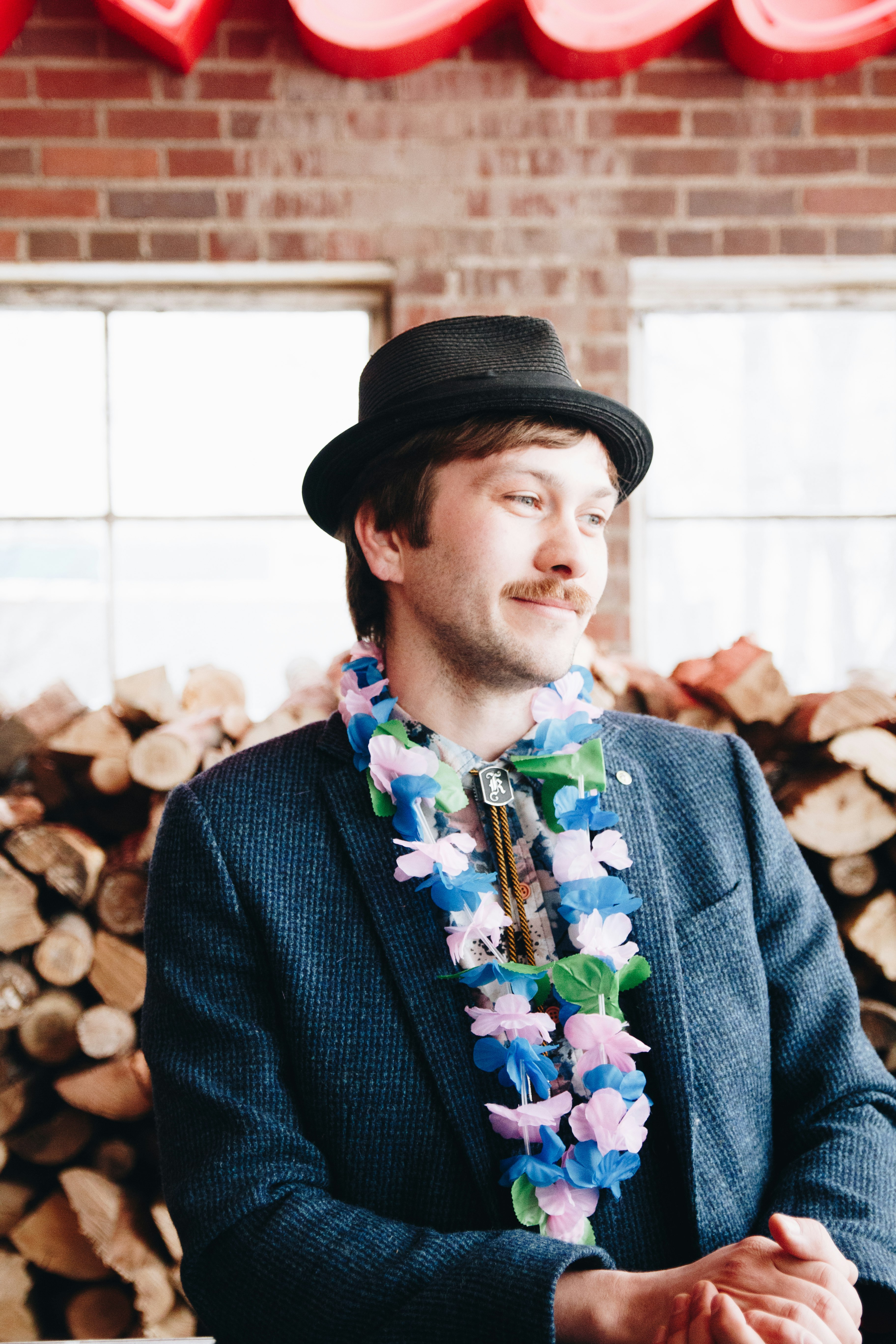 man in black hat and blue blazer